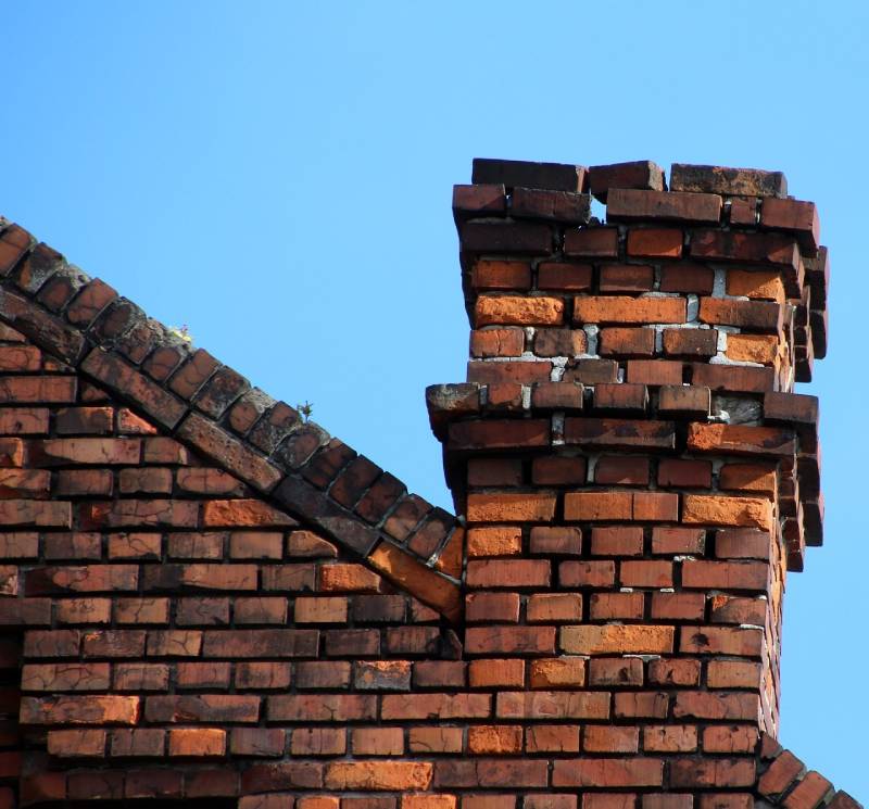 Signs Your Boylston Home Needs a Chimney Inspection Damaged chimney on an Boylston home showing cracks and missing mortar
